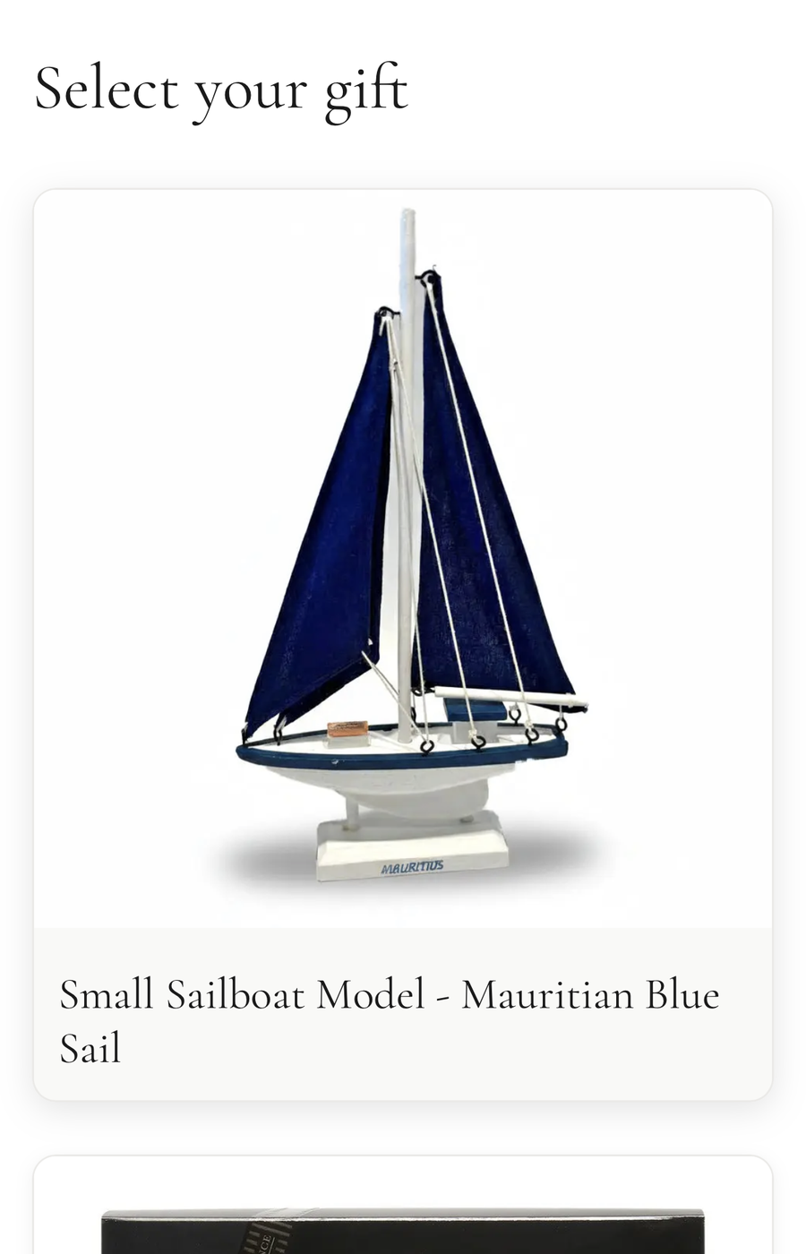 Gift recipient choosing their gift from a selection, showing a Mauritian sailboat model